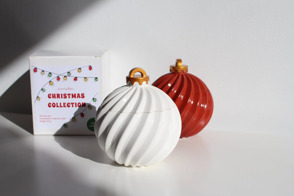 Trendy ornament candles, one white and one red, with a 'Christmas Collection' box on a light background.